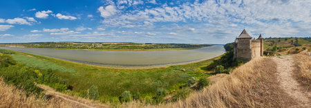 Ancient fortress in Khotyn in morning sun with mist, West Ukraine. Majestic fortification on the banks of the Dniester River, one of the most famous and largest castles in Ukraine.の写真素材