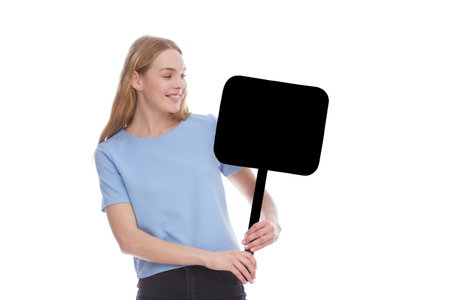emotional young woman showing empty signboard with copy space isolated on whiteの写真素材