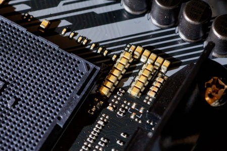 A detailed view of surface-mounted capacitors on a motherboard, showing the intricate traces and...