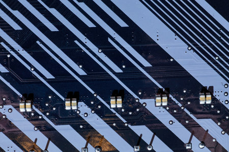 Detailed view of motherboard traces and surface-mounted components, illustrating the precision of circuit board design. This image is perfect for technical content related to electronics or PC hardware.の写真素材