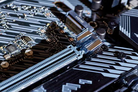 A close-up shot of a motherboard highlighting dual PCIe slots, intricate circuit patterns, and a heatsink. Perfect for use in technology illustrations, educational content, or hardware guides.の写真素材