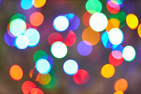 Holiday lights bokeh effect on a blurred background, showing vibrant colors and abstract patterns, ideal for festive and decorative themes.の写真素材