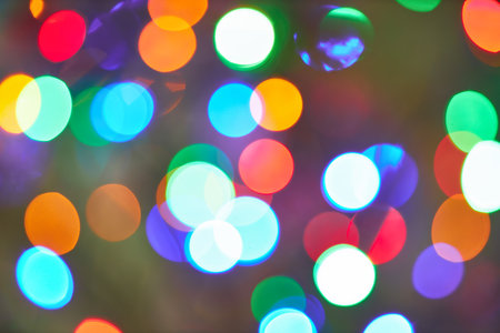 Holiday lights bokeh effect on a blurred background, showing vibrant colors and abstract patterns, ideal for festive and decorative themes.の写真素材