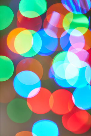 Holiday lights bokeh effect on a blurred background, showing vibrant colors and abstract patterns, ideal for festive and decorative themes.の写真素材