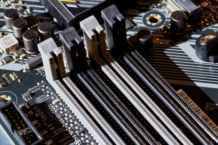 A detailed view of RAM slots on a motherboard, showing the connection points and layout for installing memory modules. Perfect for tech-related content, tutorials, or backgrounds in electronics and computing.の写真素材