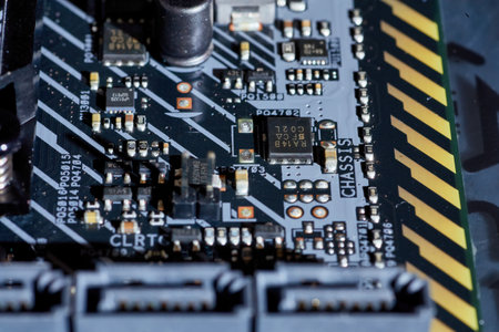 Detailed shot of various motherboard components, including capacitors, transistors, and labeled traces. This close-up provides a clear view of the intricate connections and parts, perfect for technical hardware content or tutorials.の写真素材