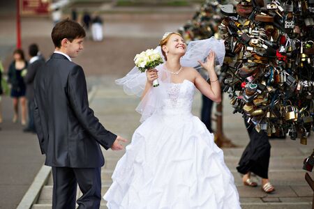 Happy bride and groom at a wedding a walk on bridgeの写真素材