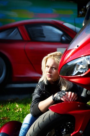 The blonde about a red motorcycleの写真素材