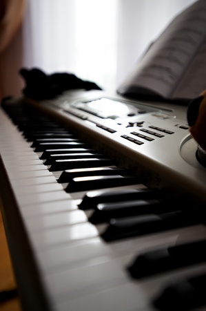 Electronic piano and a book for notesの写真素材