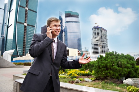 Business positive talks on the phone on the streetの写真素材