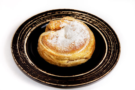 cake with icing sugar  on black plate isolatedの写真素材