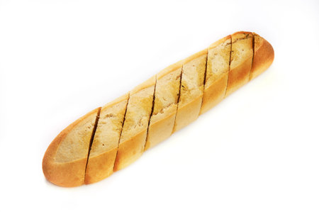 Notched loaf of bread with spices and oil isolated on white background