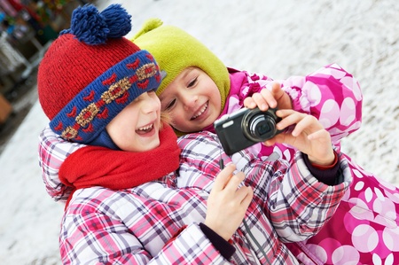 Two funny little girls with compact cameraの写真素材