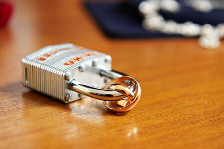 Gold wedding rings on the lock lovers. Together forever.の写真素材