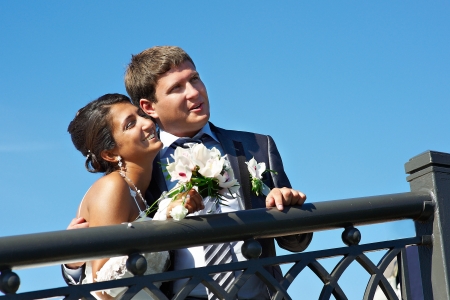 Happy bride and fiance on background blue skyの写真素材