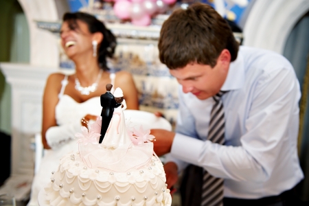 Bride and groom cut the wedding cakeの写真素材