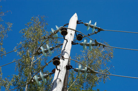 High voltage power lines against the blue sky