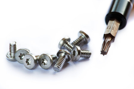 Screwdriver and screws on white background