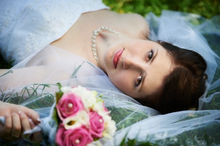 Happy bride on grass in parkの写真素材