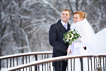 Happy bride and groom on winter wedding dayの写真素材