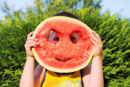 Happy boy with a big watermelonの写真素材