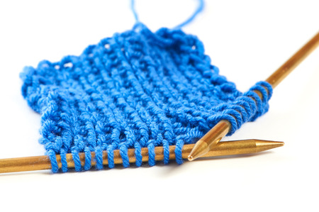 Two spokes with knit woolen cloth isolated white macroの写真素材