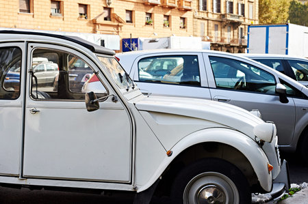 Old car in the street of the modern city