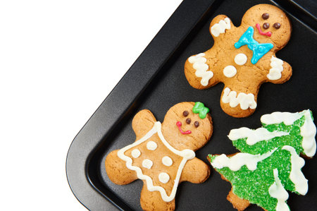 Gingerbread cookies on the pan on white background