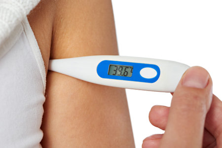 Hand of sick woman holding digital thermometer in armpits closeup