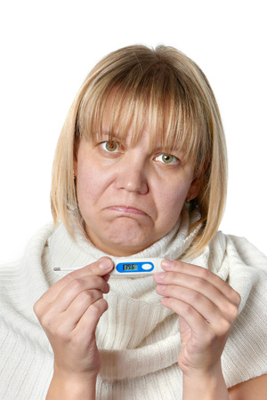 Sick woman holding digital thermometer isolated on whiteの写真素材