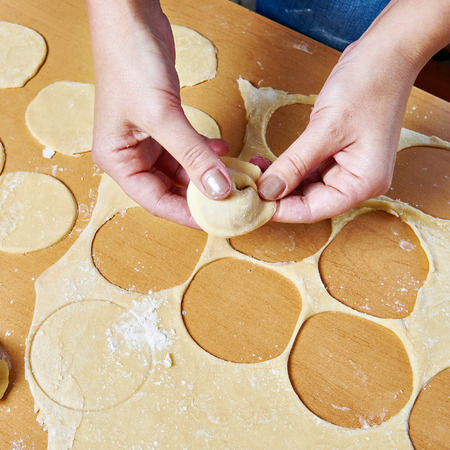 Sculpting of traditional Russian meat dumplings with minced meatの写真素材