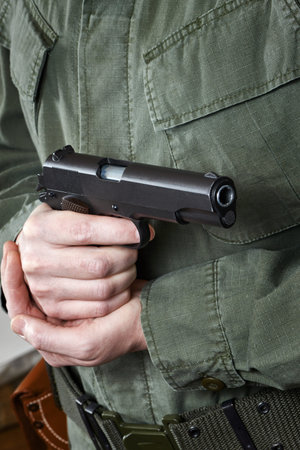 Soldier in uniform holding a gun 
