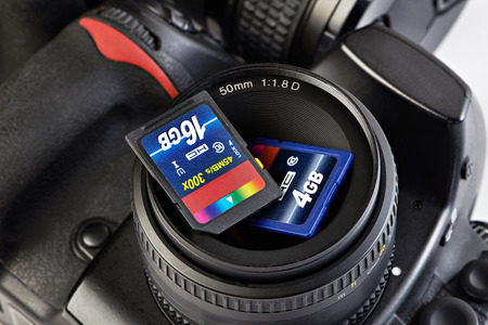 Two SD memory flash card and DSLR camera close-upの写真素材