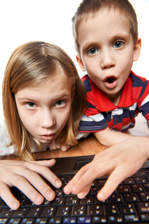 Children surprise and emotional look at the laptop screenの写真素材