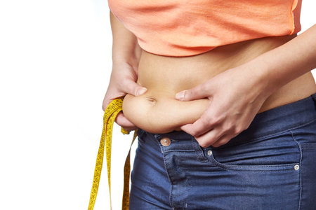 Woman with a measuring tape showing fatty deposits