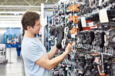 Man chooses roller skates in the sports shopの写真素材