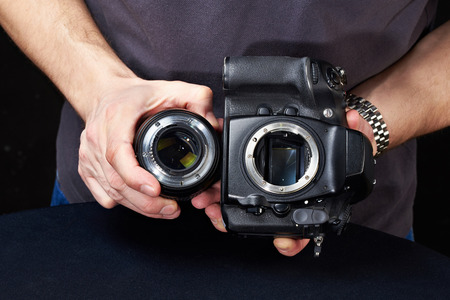 Photographer with SLR camera without the lensの写真素材