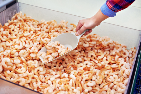 Consumer buys shrimp in the supermarketの写真素材