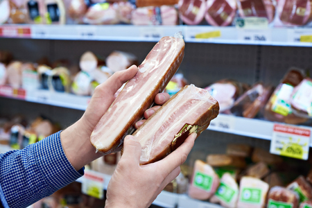 Buyer chooses the cooked ham in the shopの写真素材