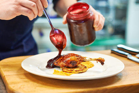 Roast duck with berry sauce on plate