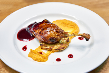 Roasted duck thigh with vegetable cutlet with sauceの写真素材