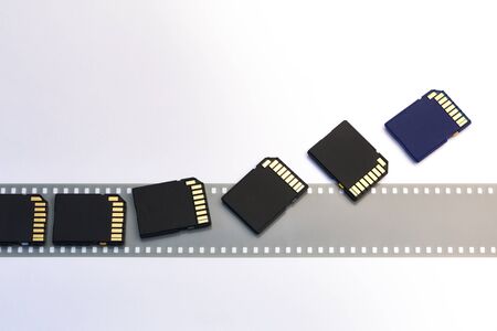 Old film and modern digital compact SD cards isolated whiteの写真素材