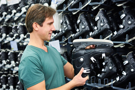 Man chooses hockey skates in the sports shopの写真素材