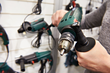 Man shopping for drill in hardware store closeupの写真素材