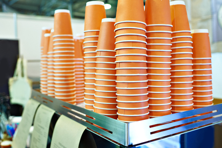 Paper orange cups for tea in a cafeの写真素材