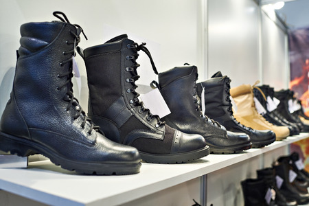 Black leather boots on the shelf in the storeの写真素材