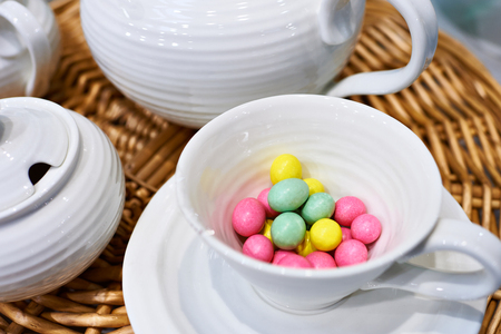 
Colorful sweet jelly beans in a porcelain mug on the tableの写真素材