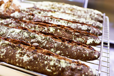Fresh baguette rye bread in bakery closeup