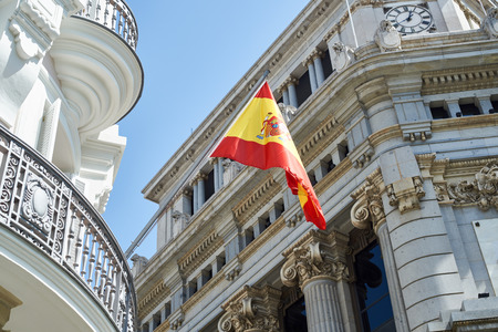 Flag of Spain on a government building in the city of Madridの写真素材