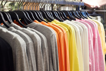Clothing on hangers in the storeの写真素材